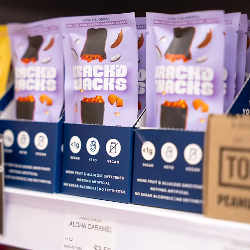 Krack’d Snacks Aloha Caramel on a store shelf, highlighting less sugar, keto-friendly, and vegan.