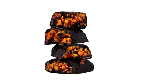 Dark chocolate Aloha caramel bars from Krack’d Snacks are stacked with visible nuts and caramel.